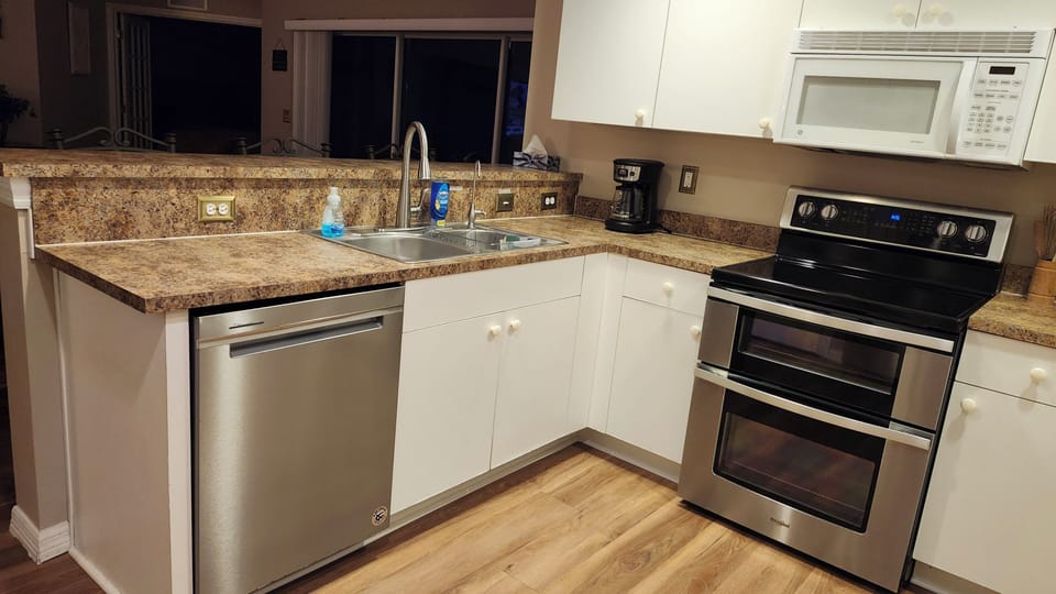 Fully functioning kitchen has all the applicances, dishes, cookware & utensils