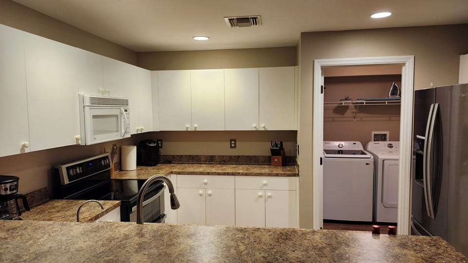 Full size fridge, freezer, ice maker, stove, oven, dishwasher, kuerig, and more