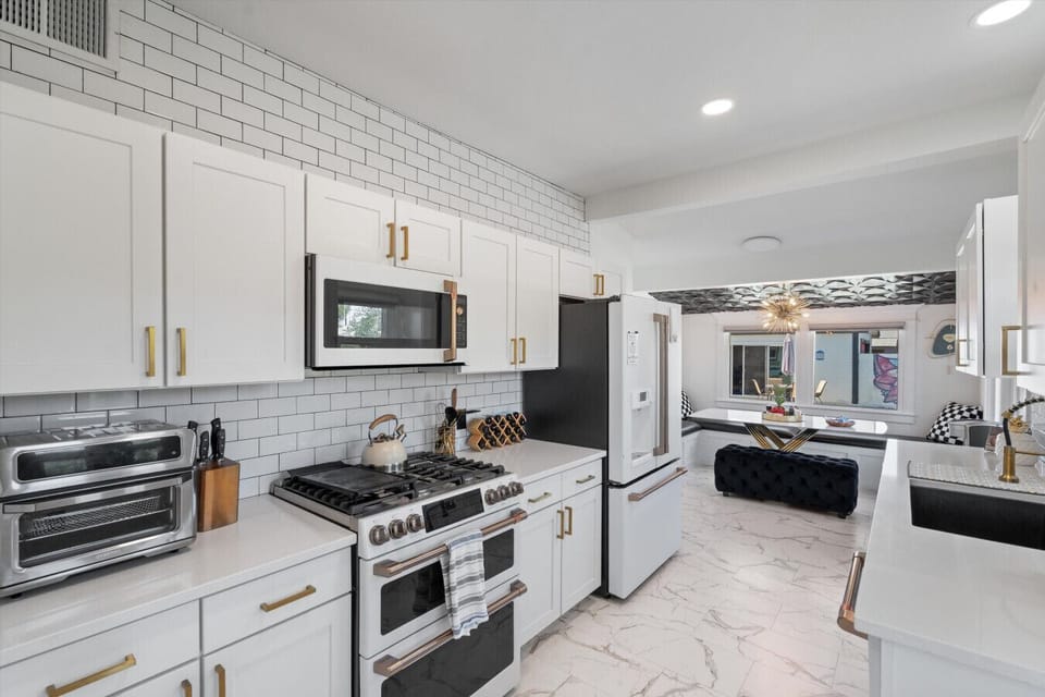 A modern kitchen made for cooking, sharing meals, and gathering together.