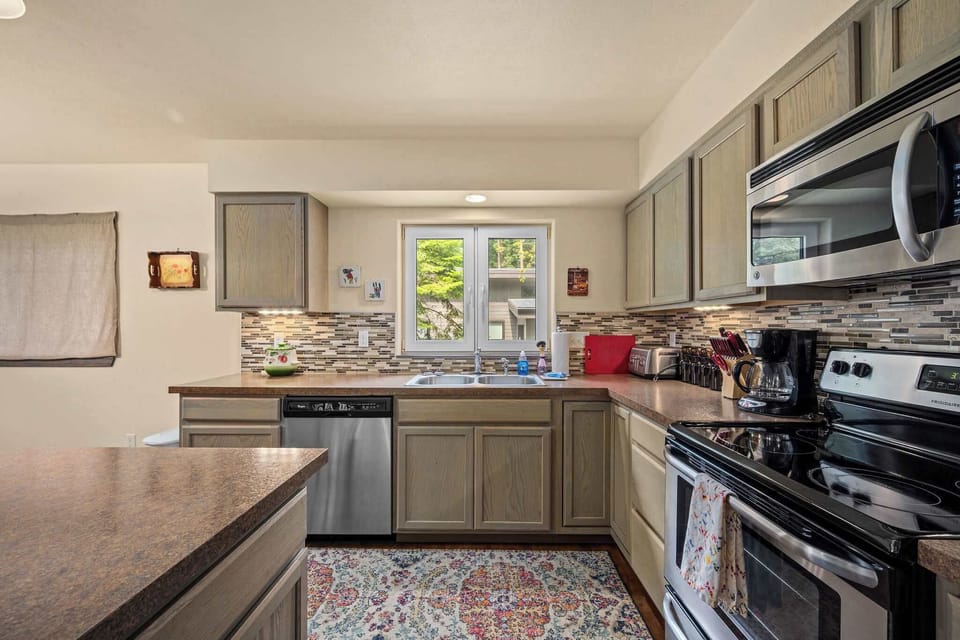 Your fully equipped kitchen features modern appliances and granite countertops, perfect for preparing home-cooked meals during your stay.