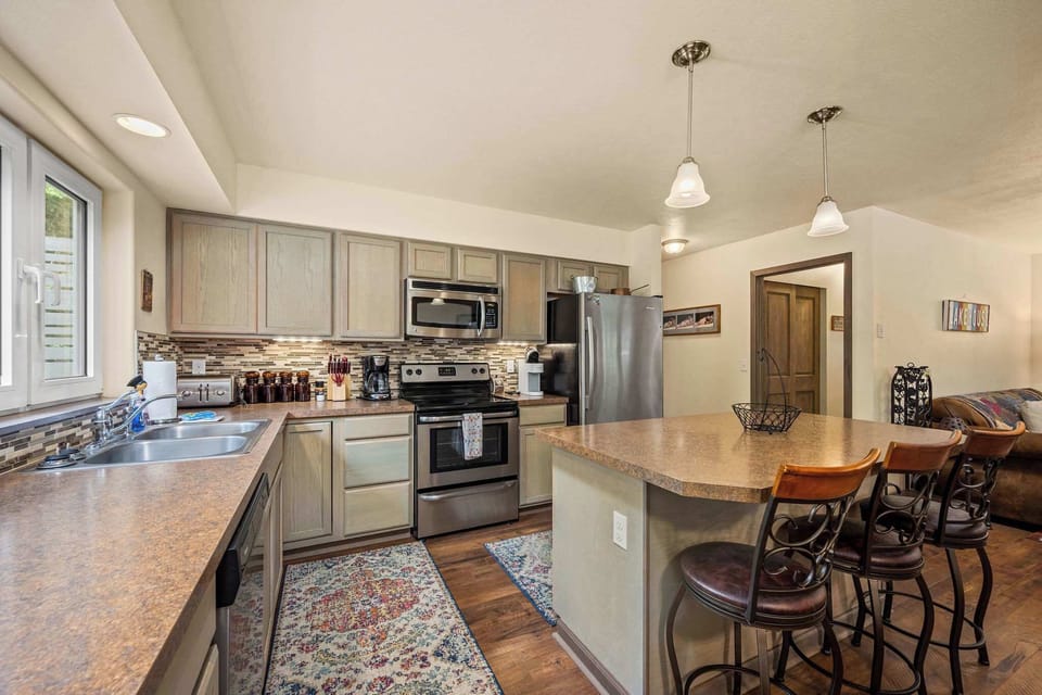 Your fully equipped kitchen invites you to create memorable meals with granite countertops, stainless appliances, and a breakfast bar perfect for morning coffee.
