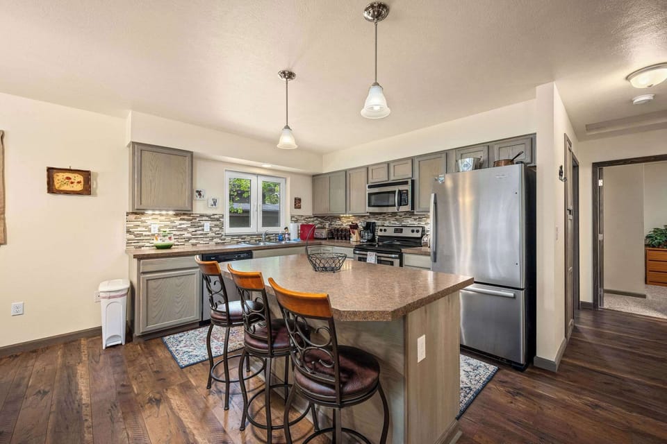Your spacious kitchen features modern appliances, granite countertops, and bar seating perfect for morning coffee or casual meals together.