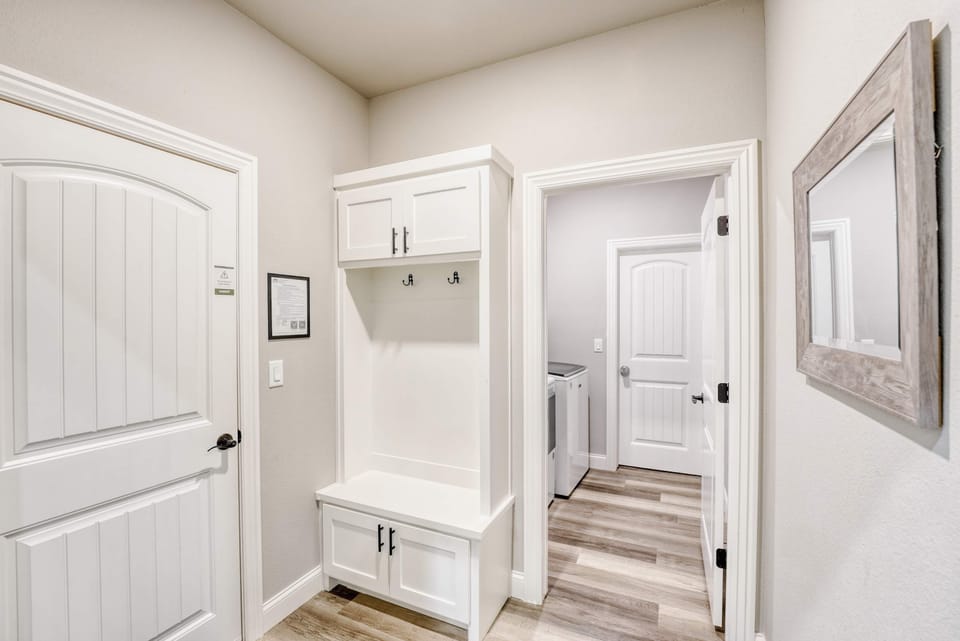 Welcoming entry with bench and hooks to keep shoes and gear organized.