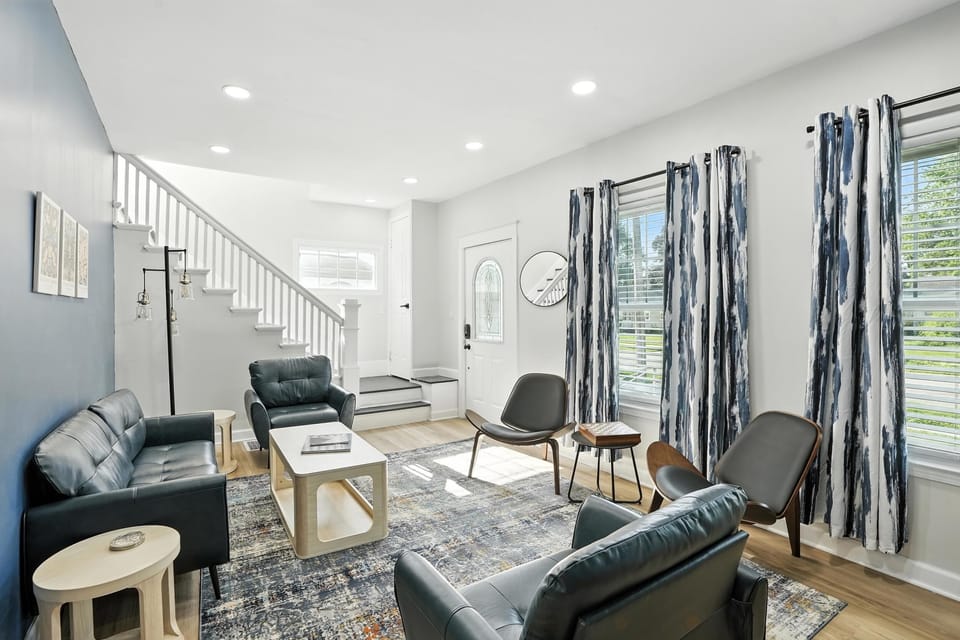 Bright and stylish living space with modern seating, statement curtains, and natural light—your cozy spot to gather, relax, and recharge.