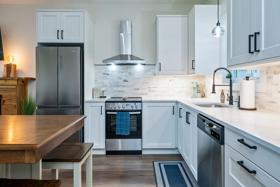 Cook like a pro in the new modern kitchen with stainless steel appliances and soft-close cabinetry.