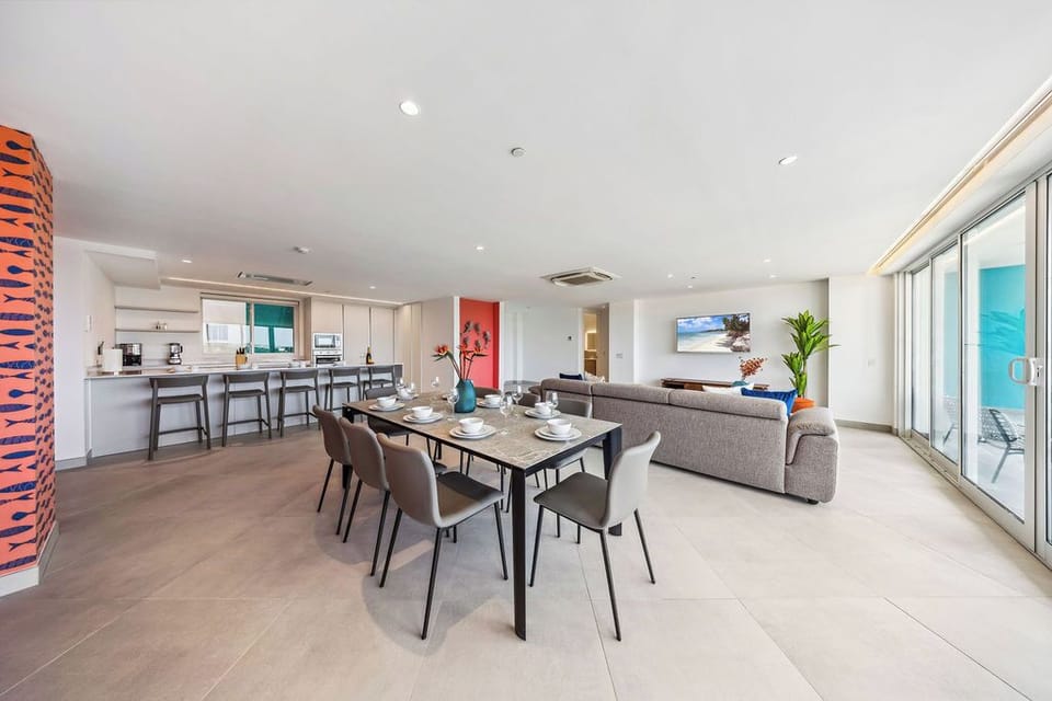Your open-concept living space flows seamlessly from kitchen to dining to lounge, with ocean views framing every moment of your island retreat.