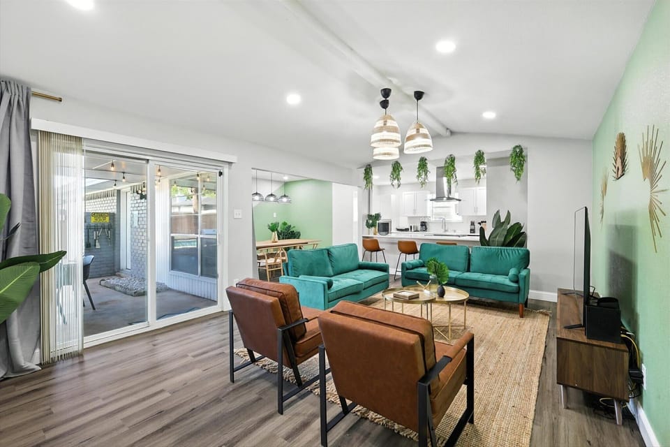 With touches of decorative greenery and plenty of seating, this living room is the perfect place to unwind after a long day and enjoy time with your companions. 