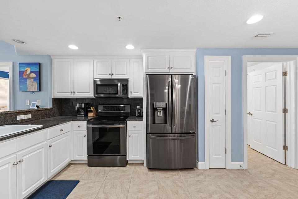 Modern kitchen with stainless steel appliances and white cabinetry