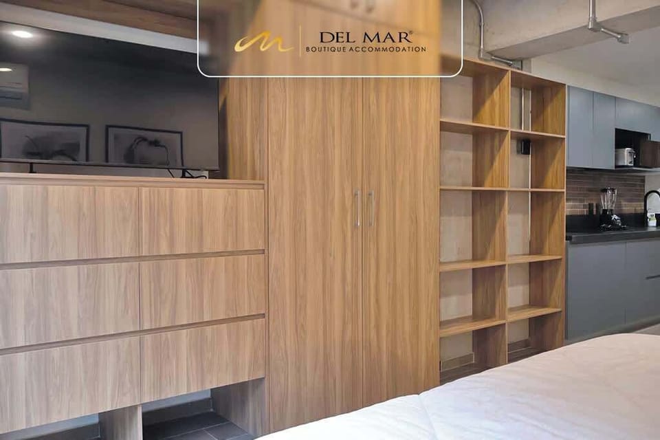 Warm wood feature wall w/ shelving & TV creating a stylish focal point in the room