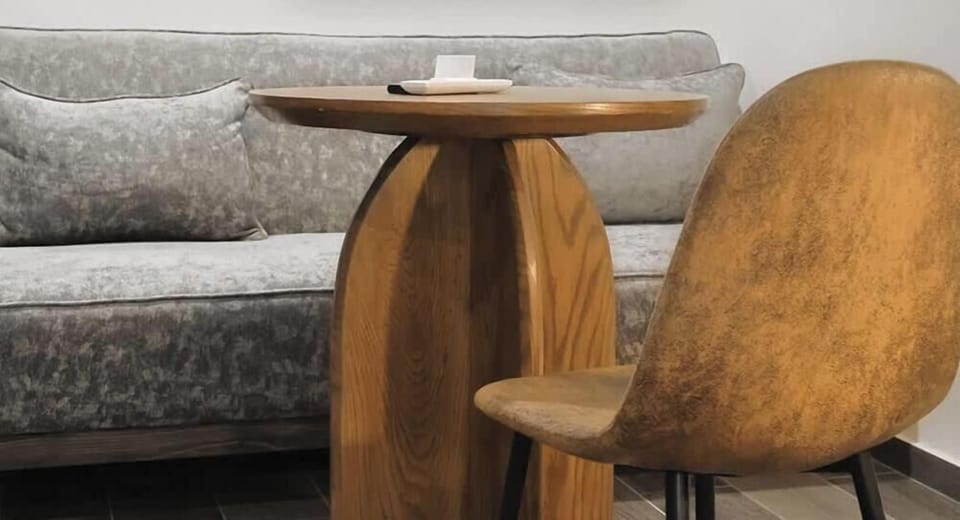 Intimate dining nook w/ round table & plush seating beside the lounge area