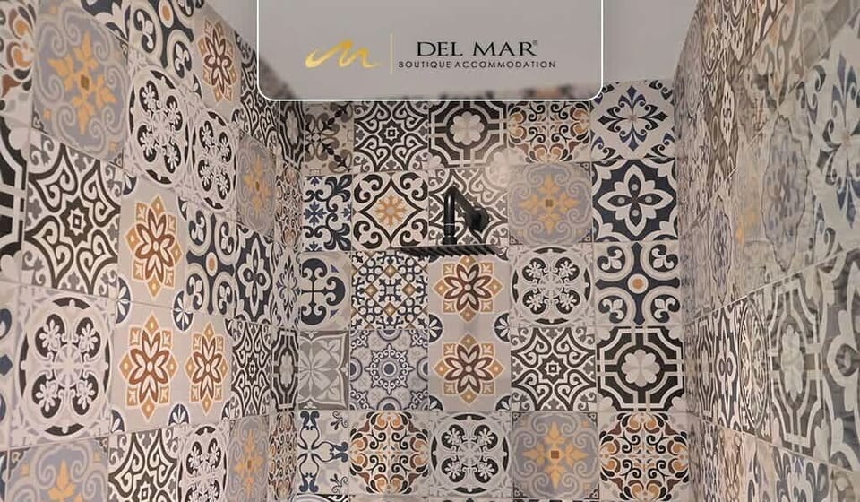 Decorative tiled shower wall adding character to the bathroom