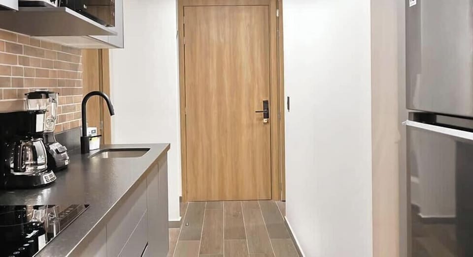 Compact kitchen corridor w/ coffee maker, microwave & convenient prep space