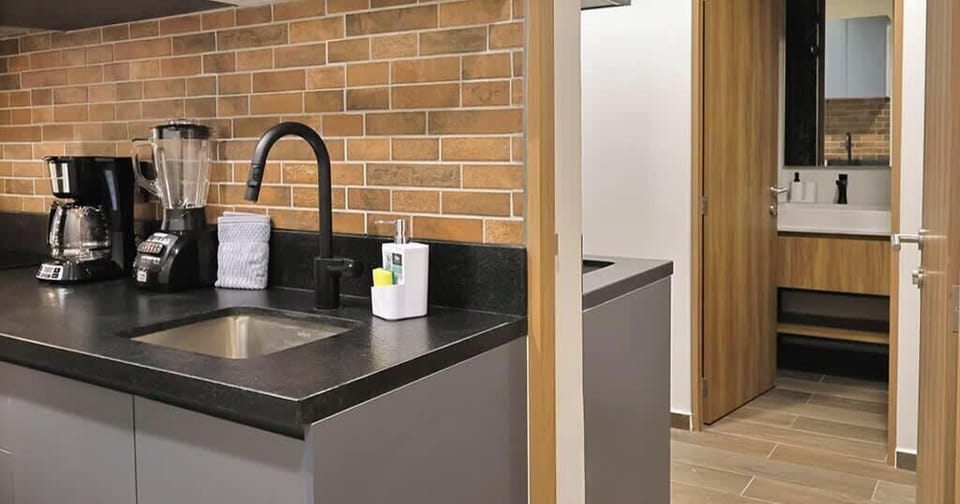 Kitchen counter w/ brick backsplash & coffee station for easy mornings