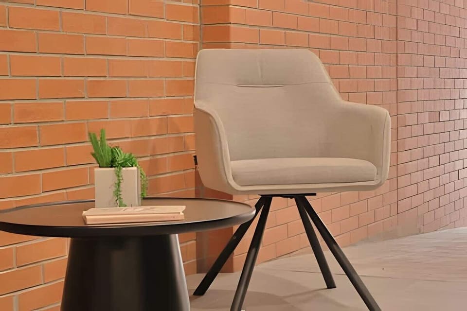 Cozy accent chair beside brick wall, a calm corner to sit & unwind