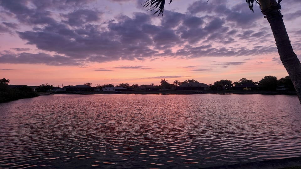 Romantic evening sky in pink and purple hues over the water – atmospheric dusk at the Cape Coral villa.