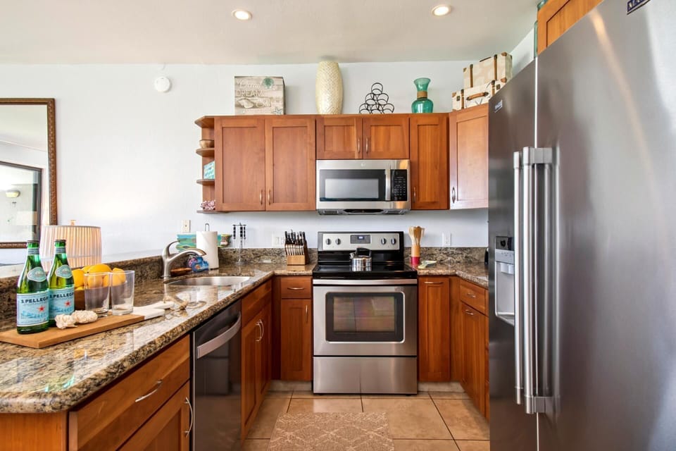 Enjoy a fully equipped kitchen with wood cabinetry and ample space

