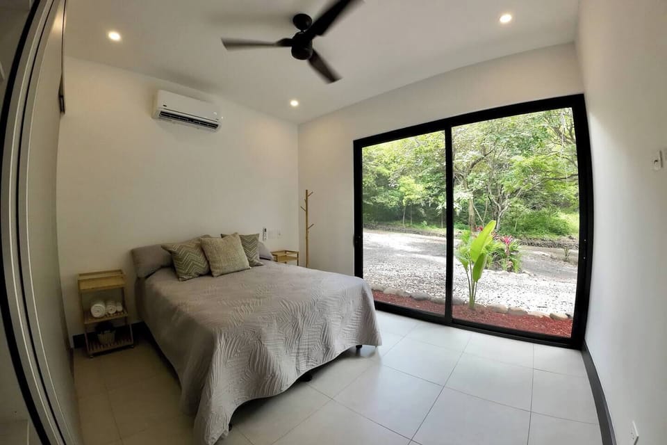 The second bedroom with a queen sized bed and walk out windows.
