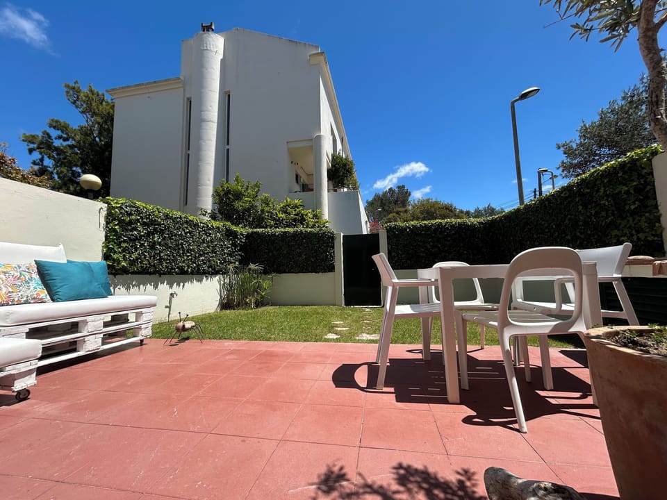 Private outdoor area with a small garden, lounge seating, and barbecue.