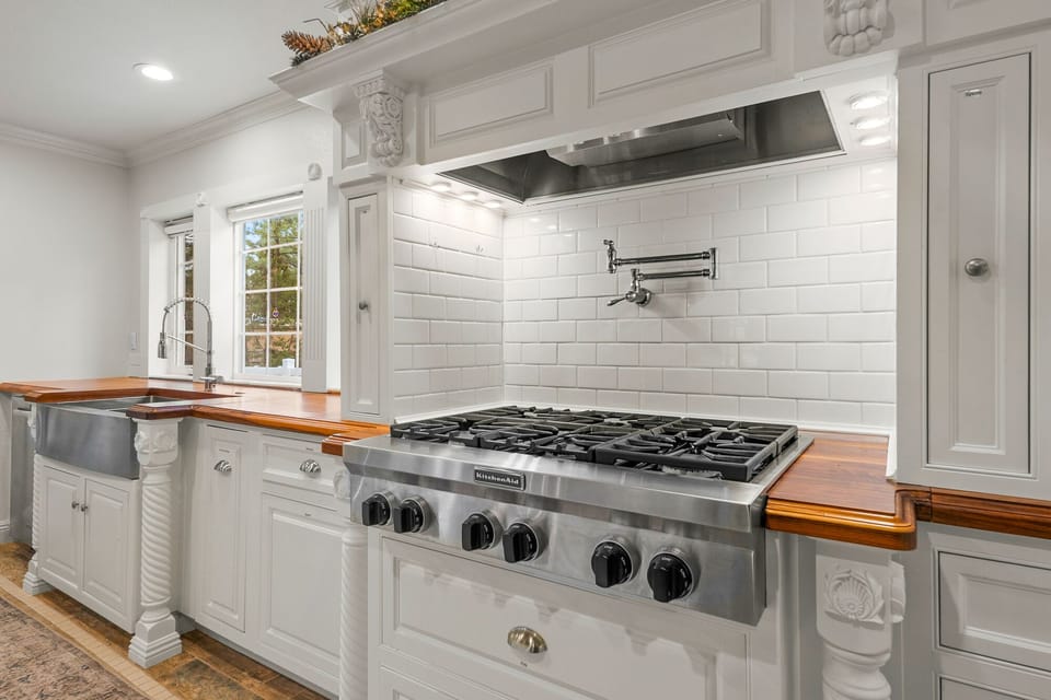 Premium gas range in a fully stocked kitchen-ideal for preparing meals for a crowd.
