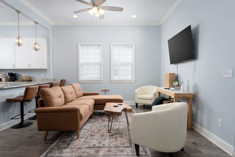 Relaxing living room with a brown sectional and open-concept kitchen.