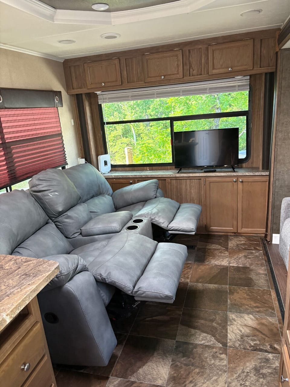 Kick back and get cozy—this comfy living space features a reclining sofa, big windows with lake views, and all the relaxing vibes you need after a day on the water