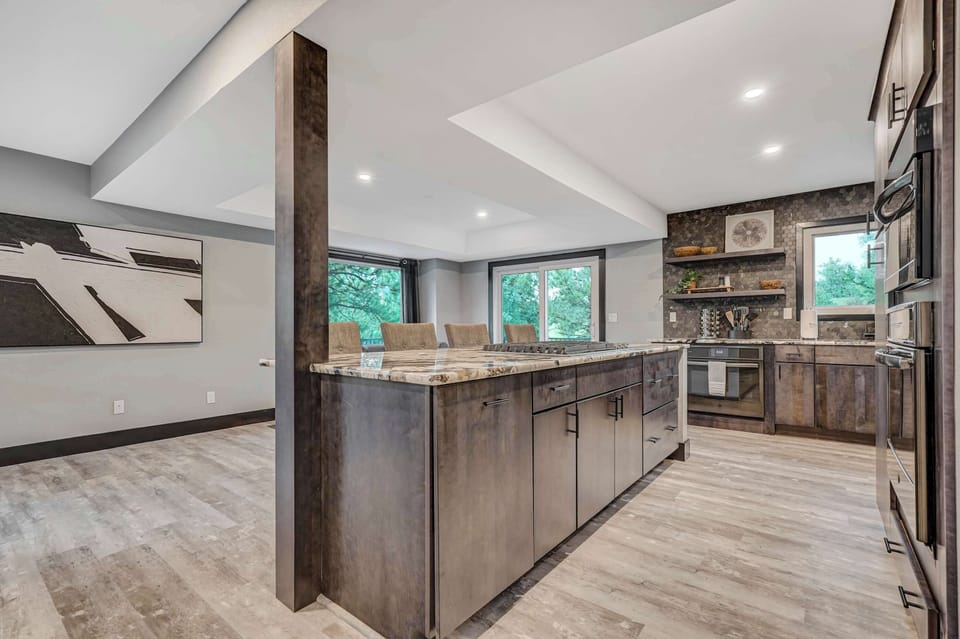 Modern open kitchen with granite island and seamless flow into the dining and living spaces—great for entertaining.