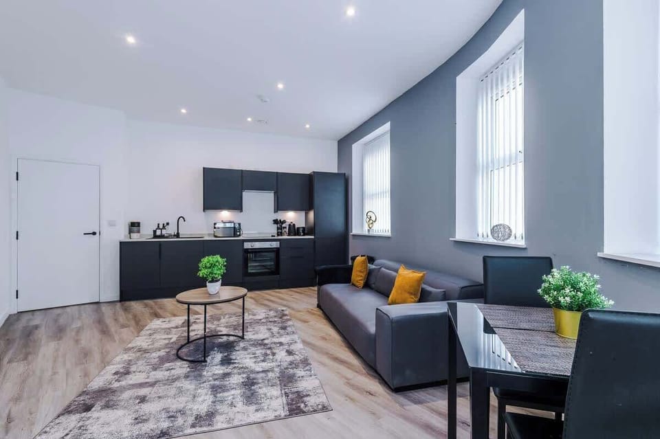 Full Kitchen View with Living Room and Dining Set Up 