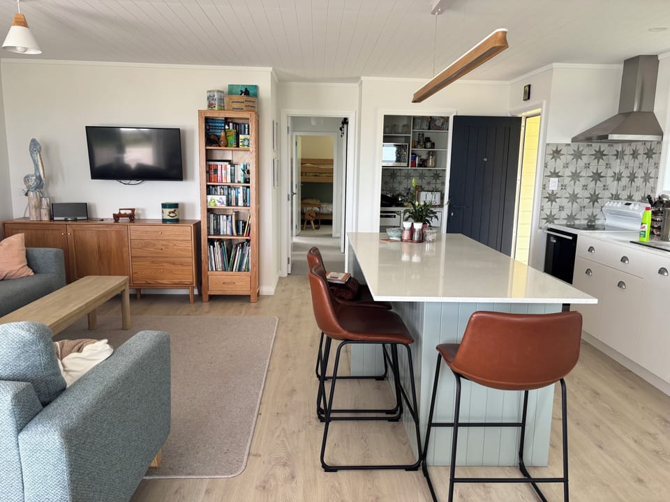 Open space dining, kitchen and lounge makes a light, picturesque space to relax