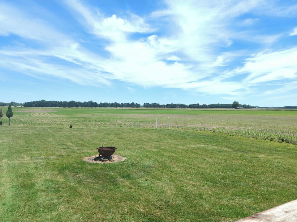 Fire pit in the backyard, shared with downstairs guests.  Fields behind the house.