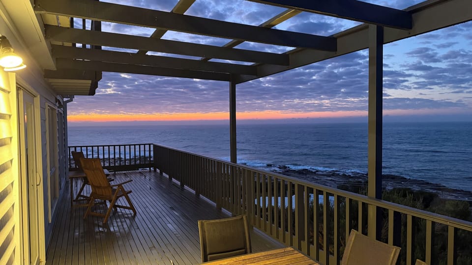 Sunrise over the ocean from the expansive deck