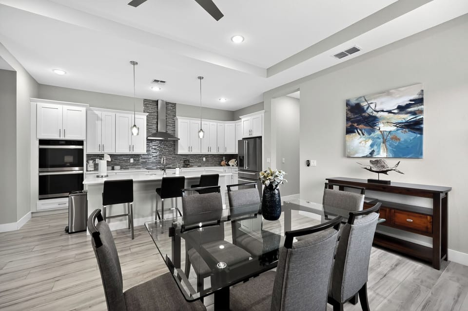 Dining Room: Entertain in style with a sleek glass table and modern touches! Enjoy culinary delights!