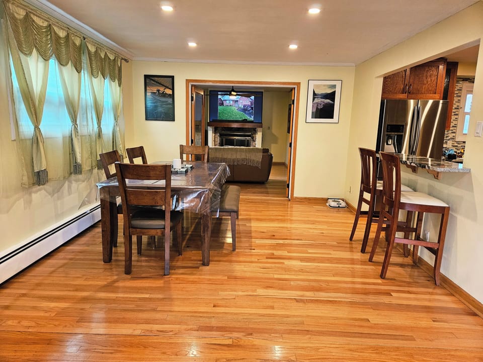 Dining room area, which includes a breakfast bar, facing the kitchen.