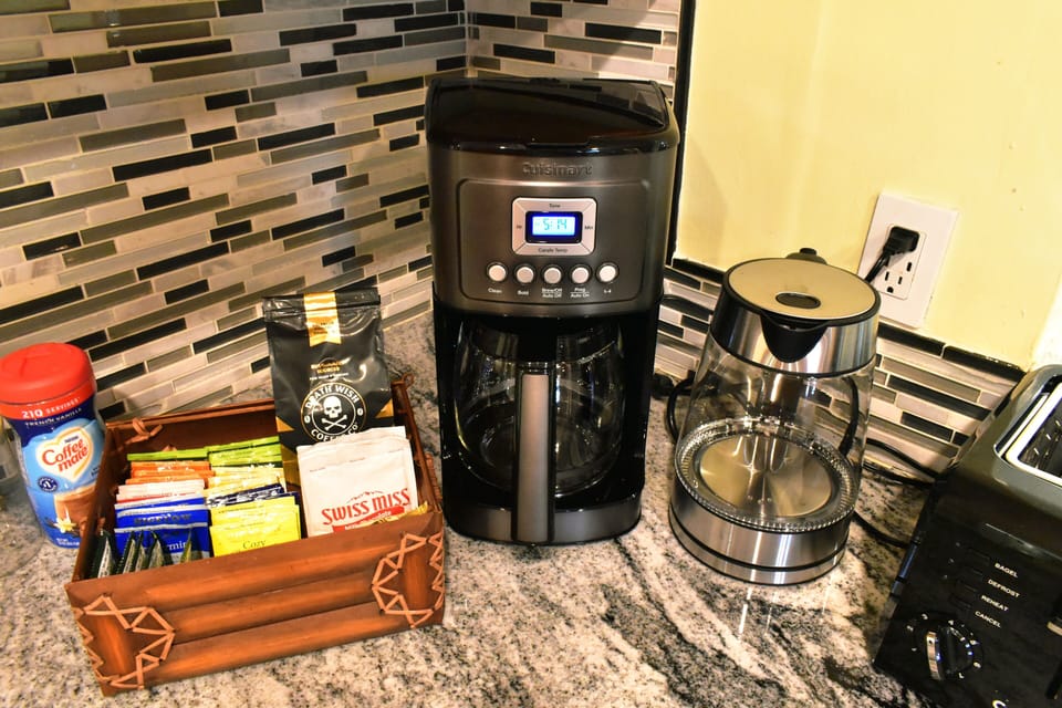 Kitchen equipped with assortment of teas, coffee, and hot chocolate and more.