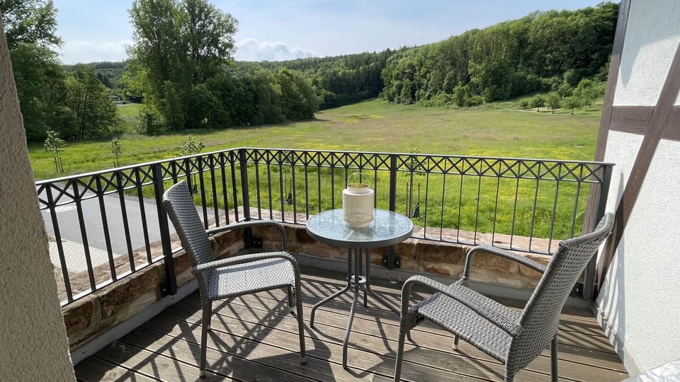 Outdoor seating area with a wide view of the greenery.