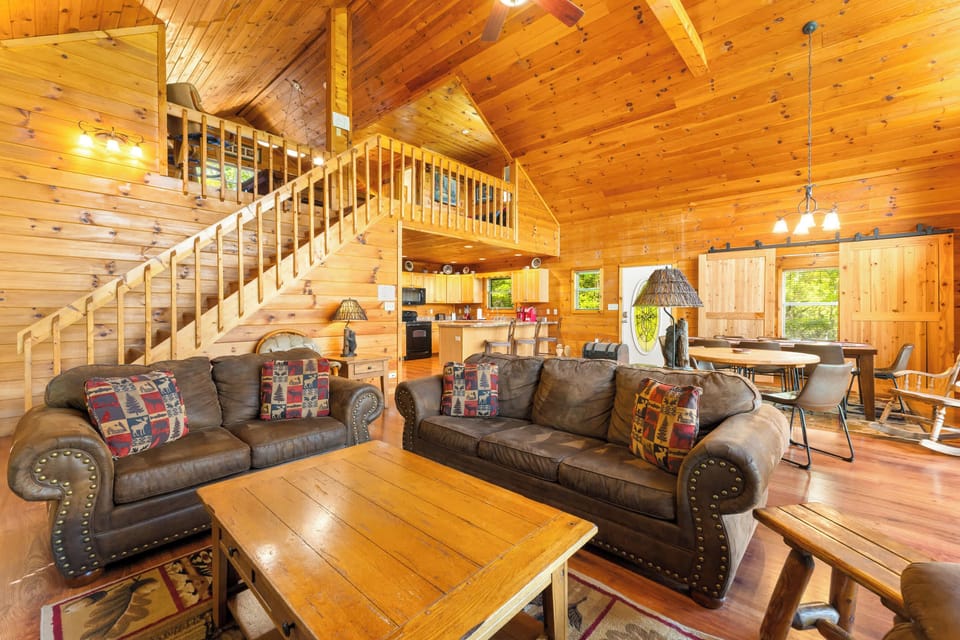 Spacious living room with a gas fireplace, full size sofa sleeper, and smart TV