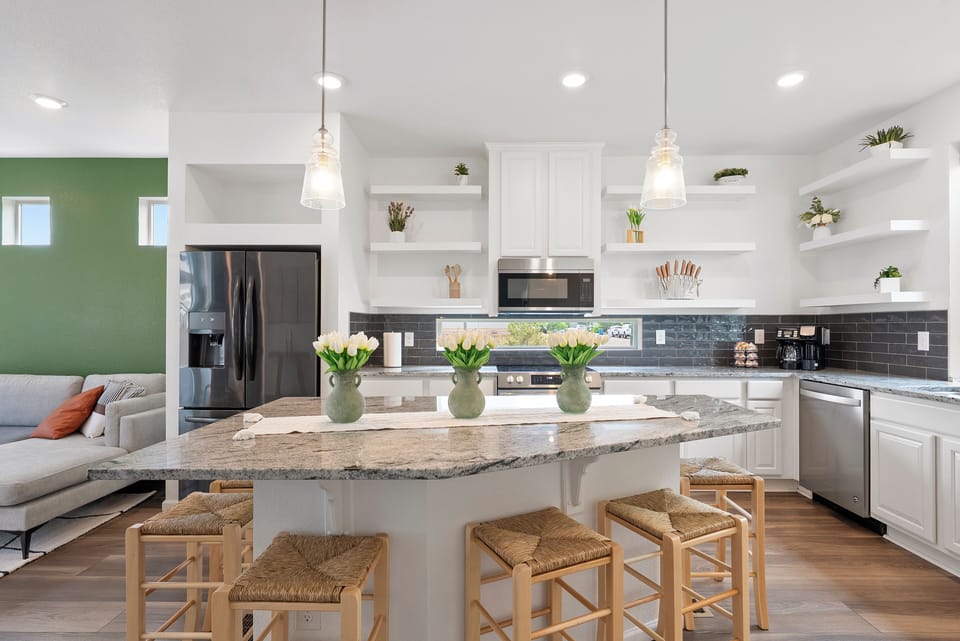 Modern kitchen with granite island and seating for six.
