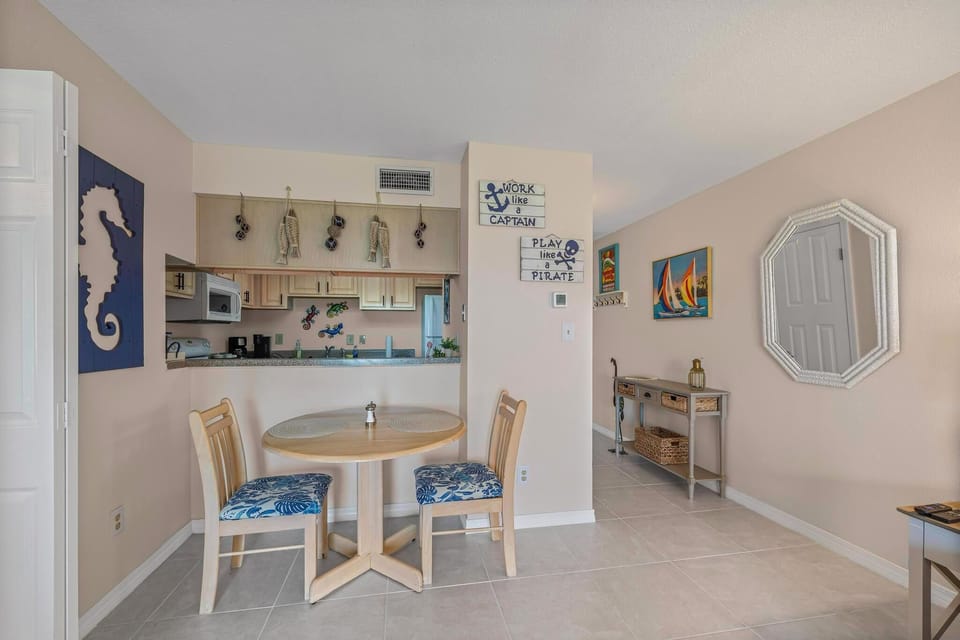 Bright dining area with nautical decor, adjacent to the open kitchen.