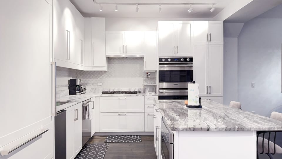 Gourmet kitchen with marble countertop, high-end appliances