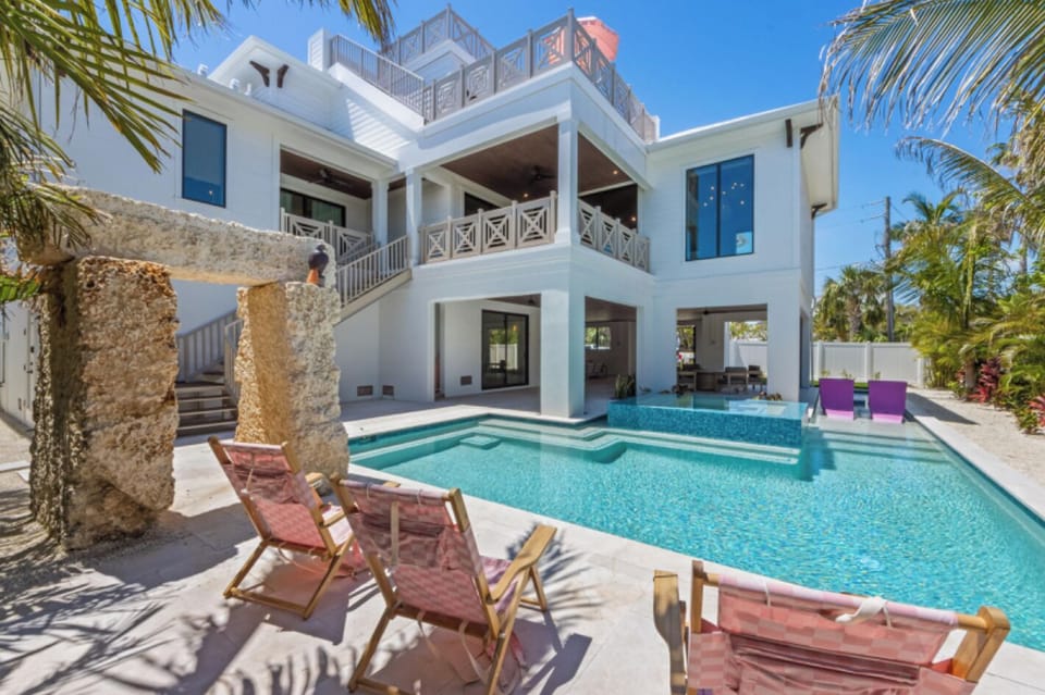 Spacious heated pool with tanning deck and spa