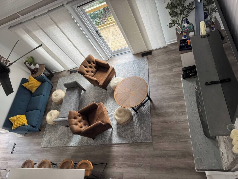 Main floor living room with lake view, open concept and 70" TV. 