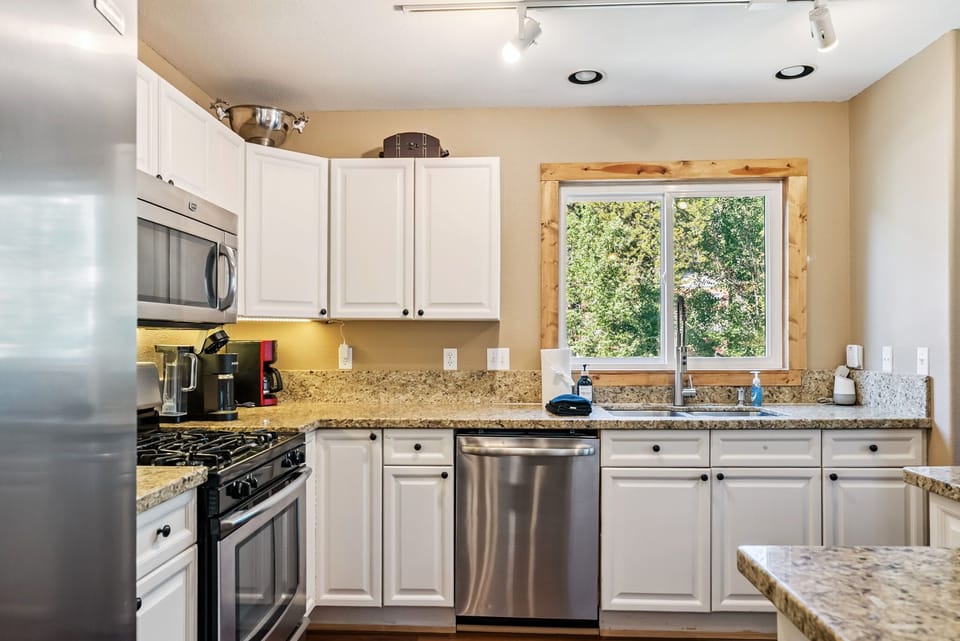 Kitchen: Main floor, drip coffee maker, Keurig, toaster, cooking utensils, tableware