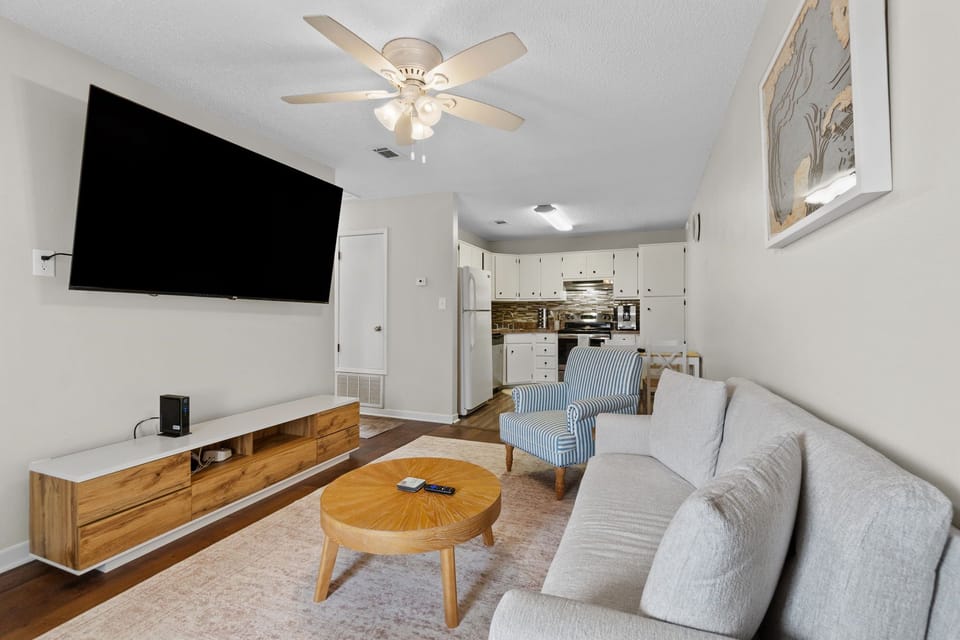 The open layout flows seamlessly into the fully equipped kitchen and dining area, creating the perfect spot for family dinners, game nights, or remote work.