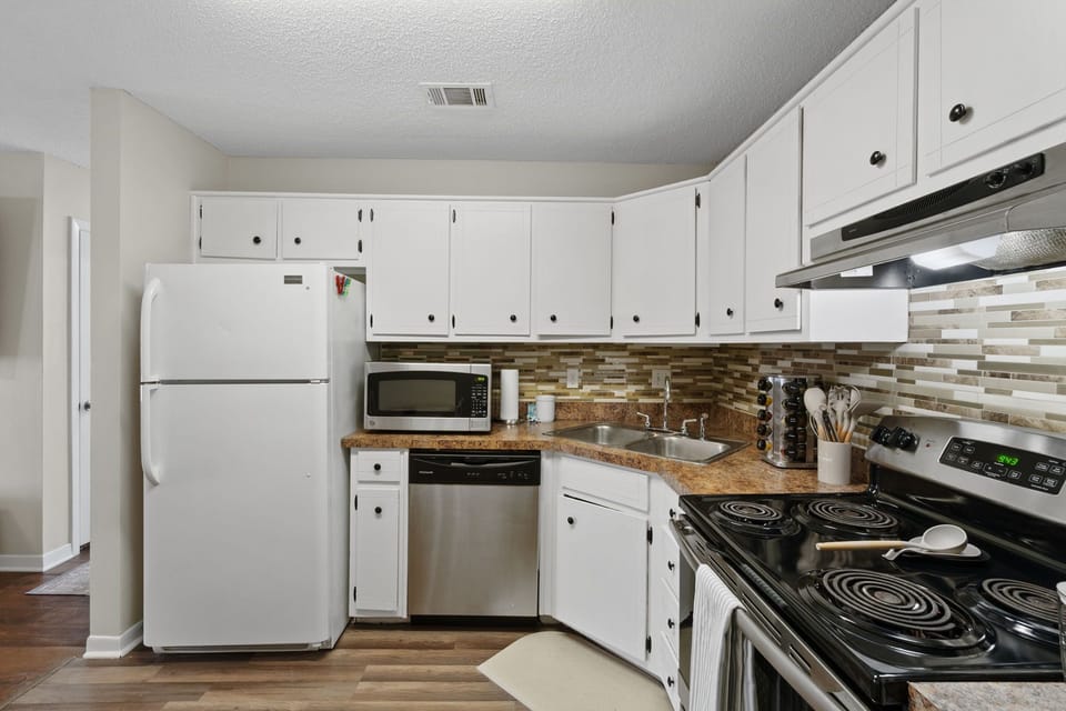 Stainless steel appliances, a full-size fridge, microwave, coffee maker, and all the essentials.