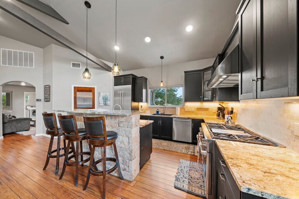 Our fully stocked kitchen features high-end appliances, a spacious layout, and a large island with bar-height seating—perfect for morning coffee, casual meals, or just hanging out with the chef.
