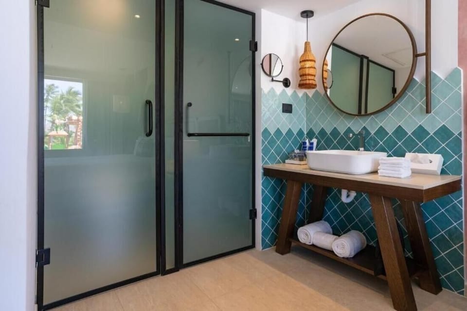 Refresh in a spa-inspired bath with rain shower and artisan tiles.