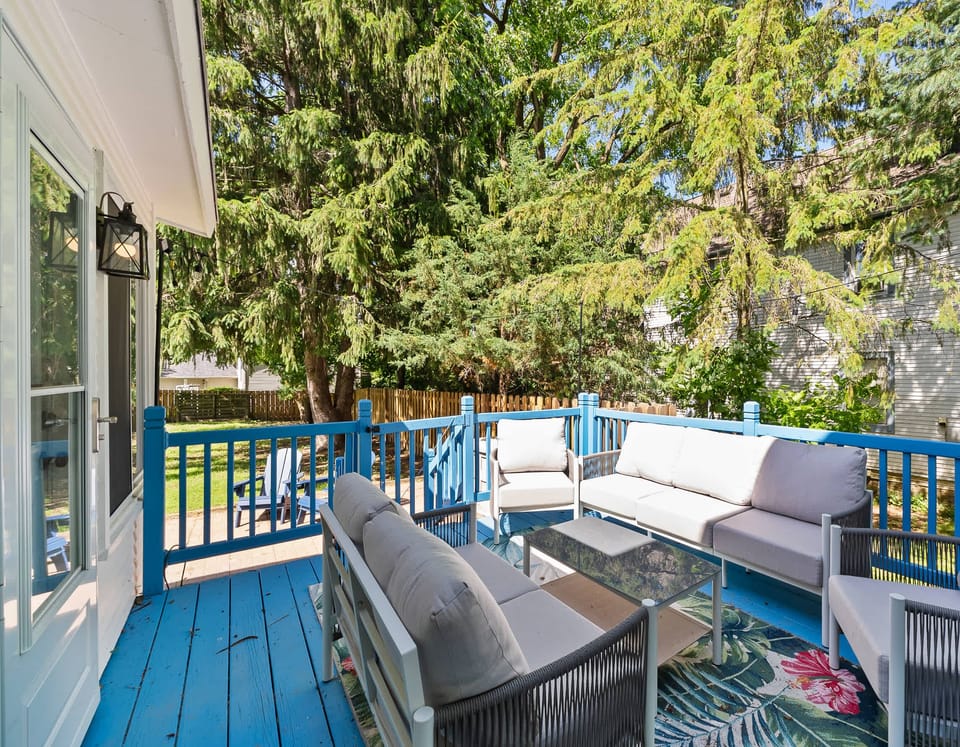 Outdoor Living Room: A spacious deck equipped with comfortable cushioned furniture. The perfect spot for your group to gather, relax, and soak up the sun.