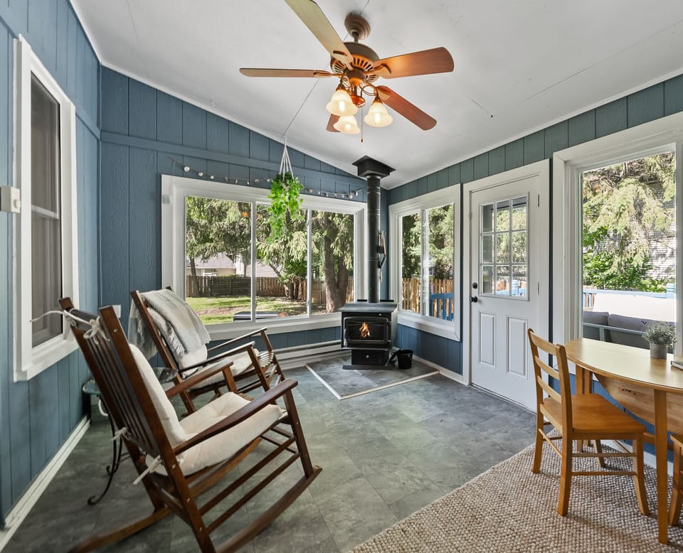 Enjoy year-round relaxation in the screened porch, featuring cozy seating and a wood stove for cooler evenings. A favorite spot for morning coffee, reading, or unwinding while surrounded by nature.