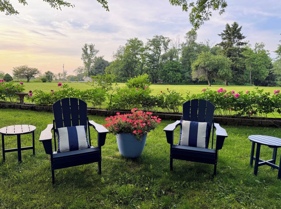 Huge yard with plenty of seating to enjoy the scenic views in a wooded setting.