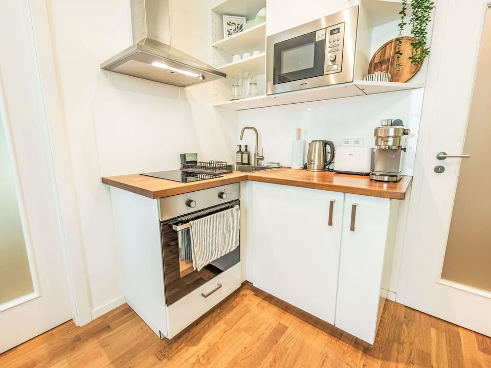 Furniture, Interior Design, Flooring, Wood, Floor, Cabinetry, Countertop, Room, Kitchen, Wood Flooring