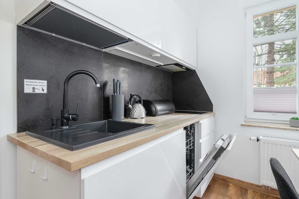 Kitchenette with dishwasher and refrigerator. 